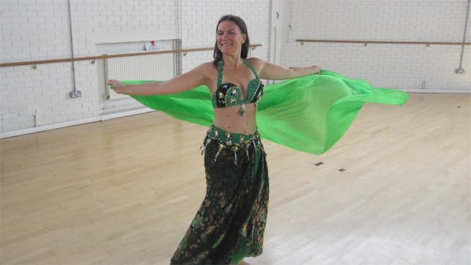 Dancing in a green belly dance costume